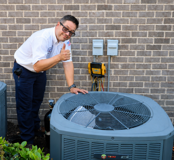 Climate Heroes technician servicing an outdoor unit